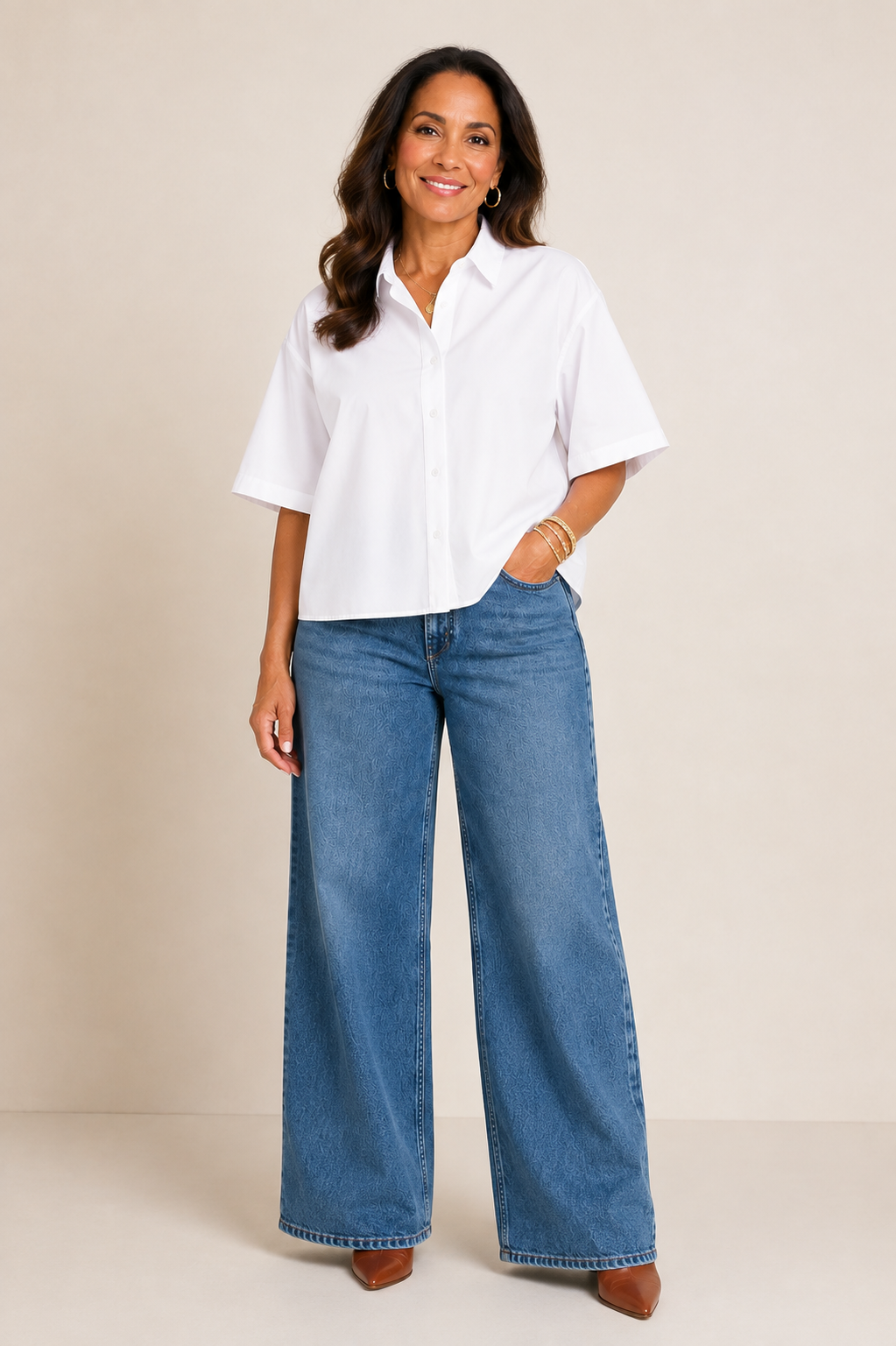 Woman in her 50s wearing wide leg jeans.