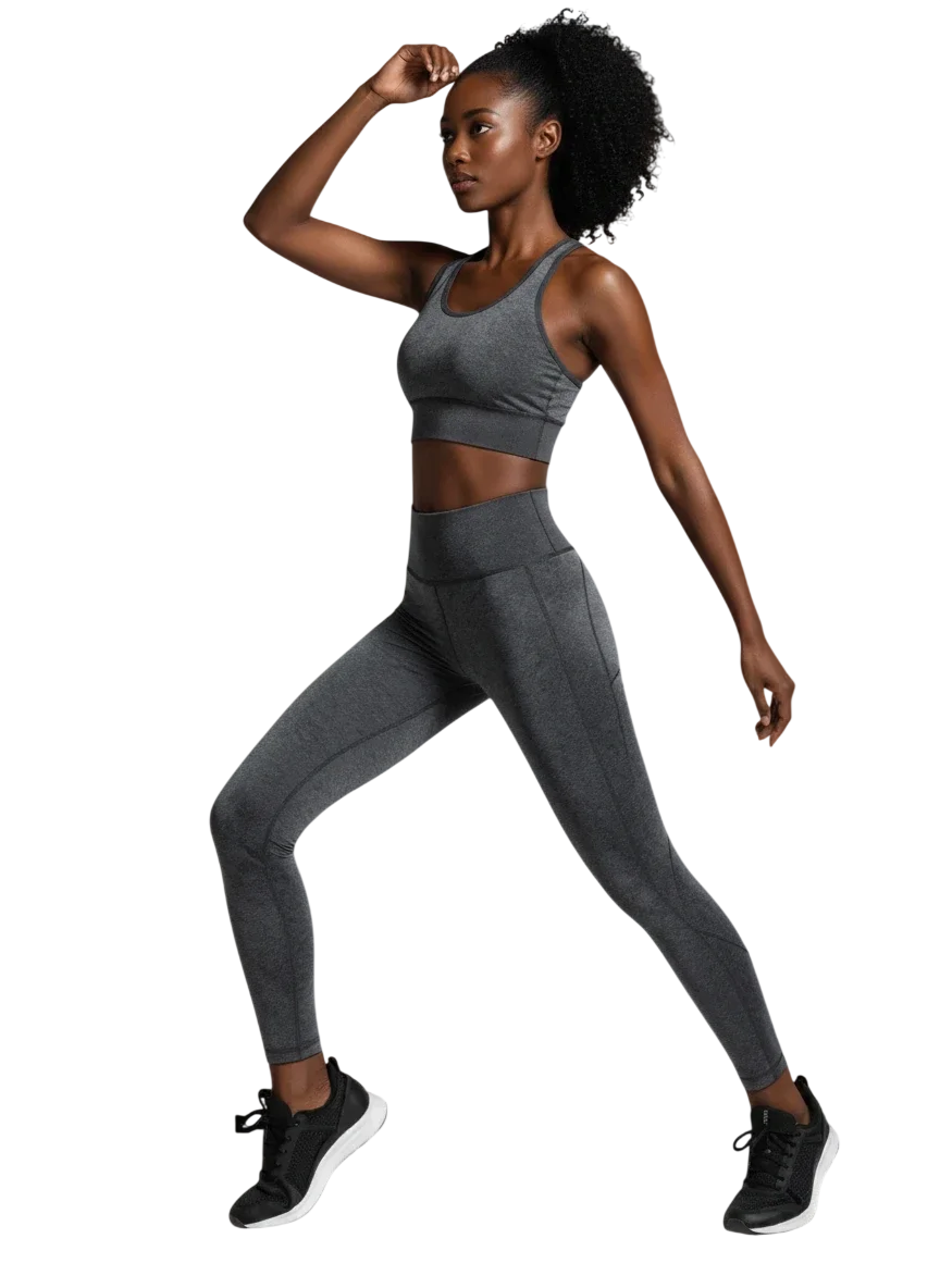 A fit woman in athletic wear poses against a plain background.