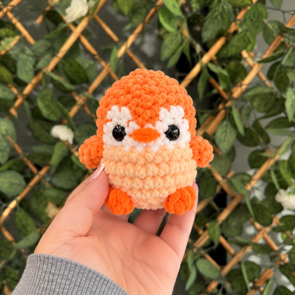 Handmade Plush Bird in a Leafy Garden.png