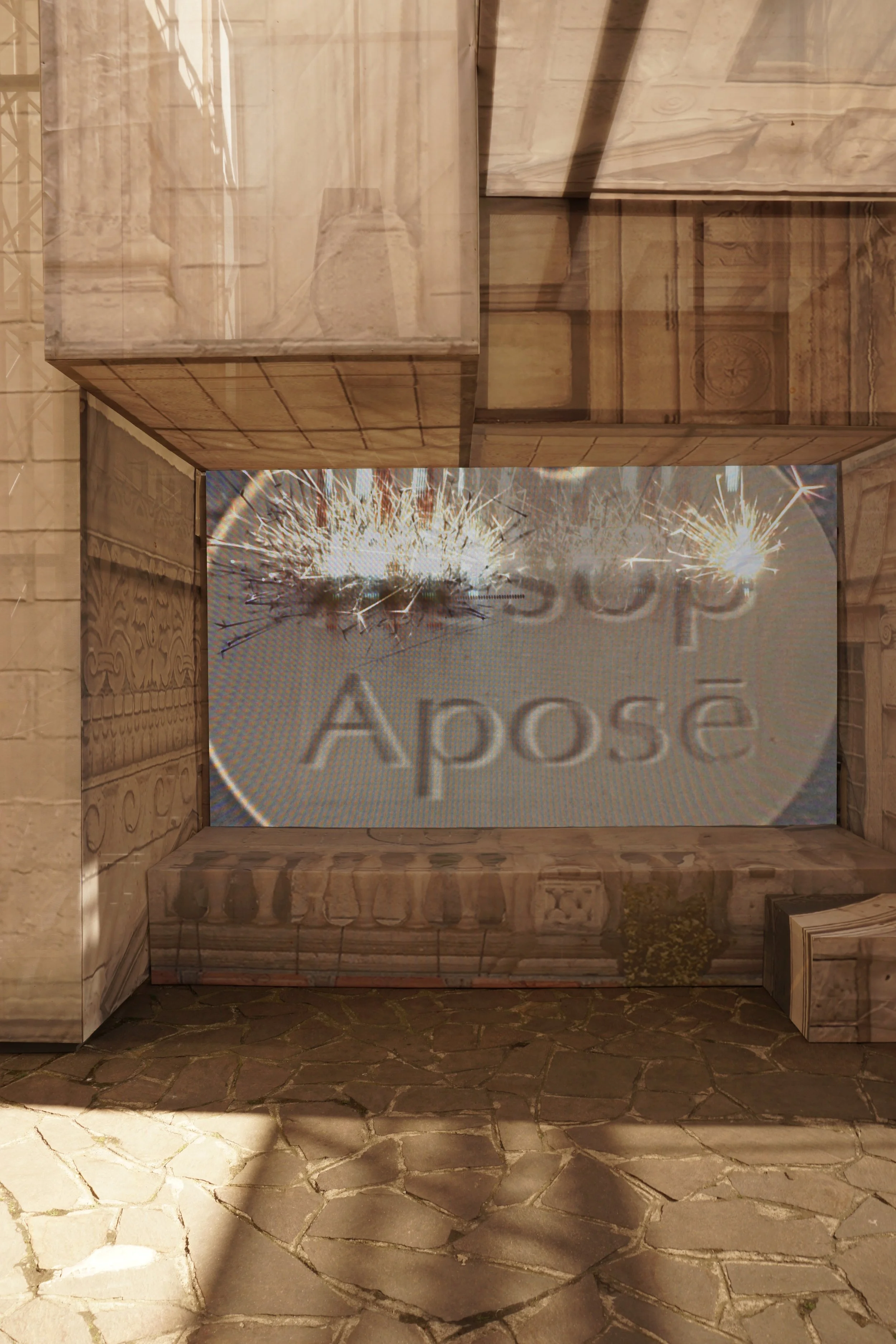 A display with a wooden frame and a sign reading 'Apose' illuminated by streetlights, with a sparkler flickering inside.