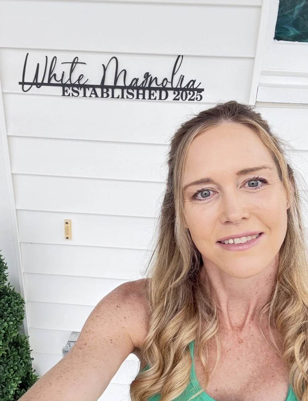 Allie Demers, Founder of White Magnolia Living, in front of her first property, White Magnolia Galveston.