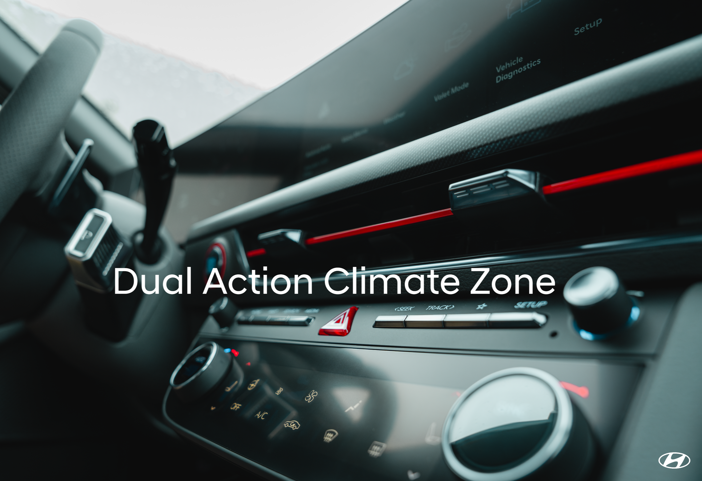 Close-up of a car dashboard displaying the text 'Dual Action Climate Zone' on the screen.