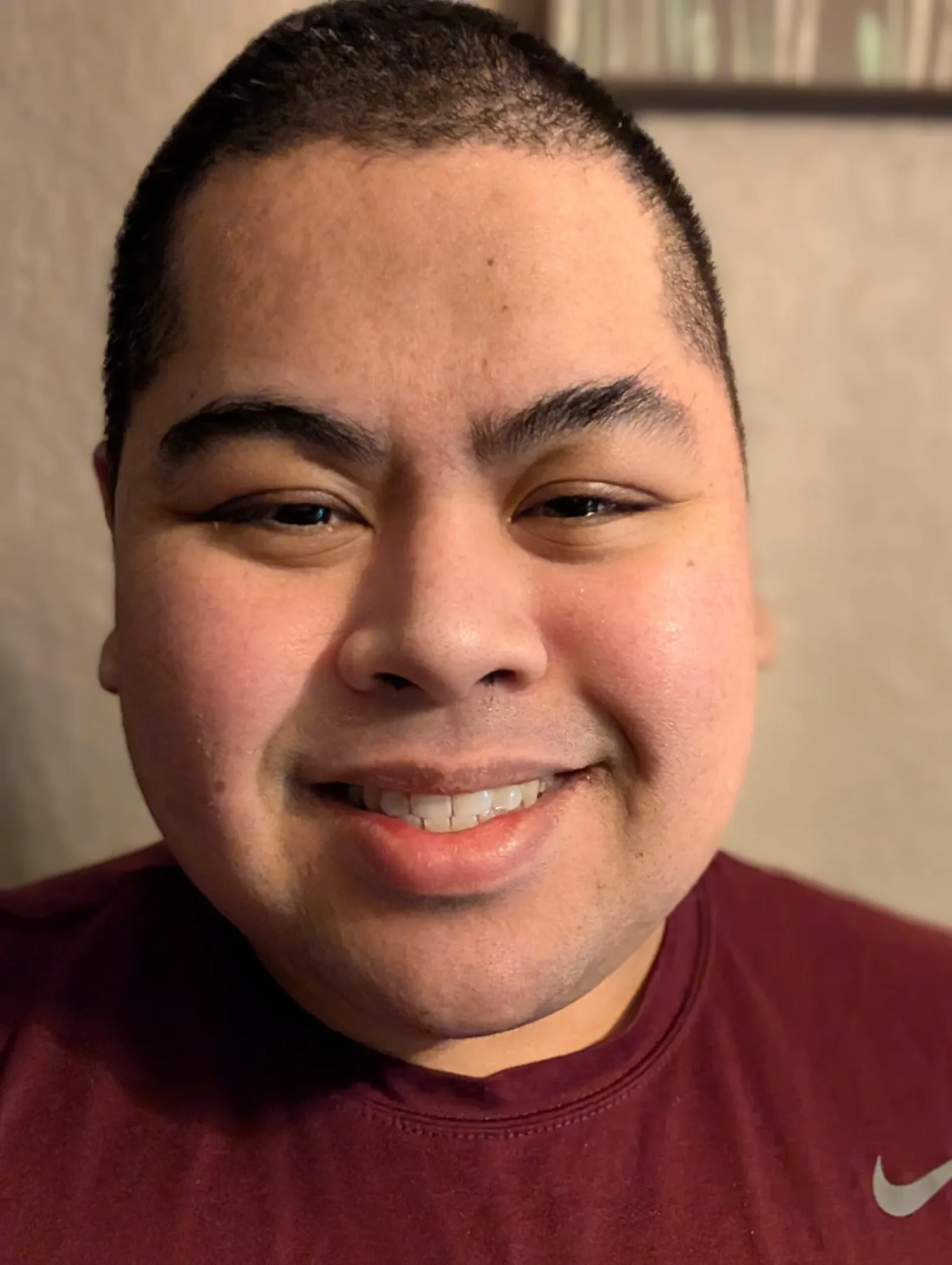 Noah smiling in a red shirt