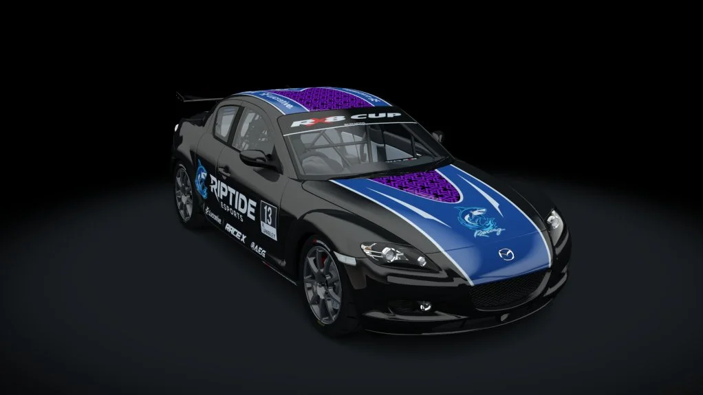 Black and blue Mazda race car with sponsorship decals, parked on a dark surface against a black background.