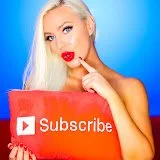 Woman with long blonde hair holding a red 'Subscribe' button sign, pointing at her cheek, against a blue background.