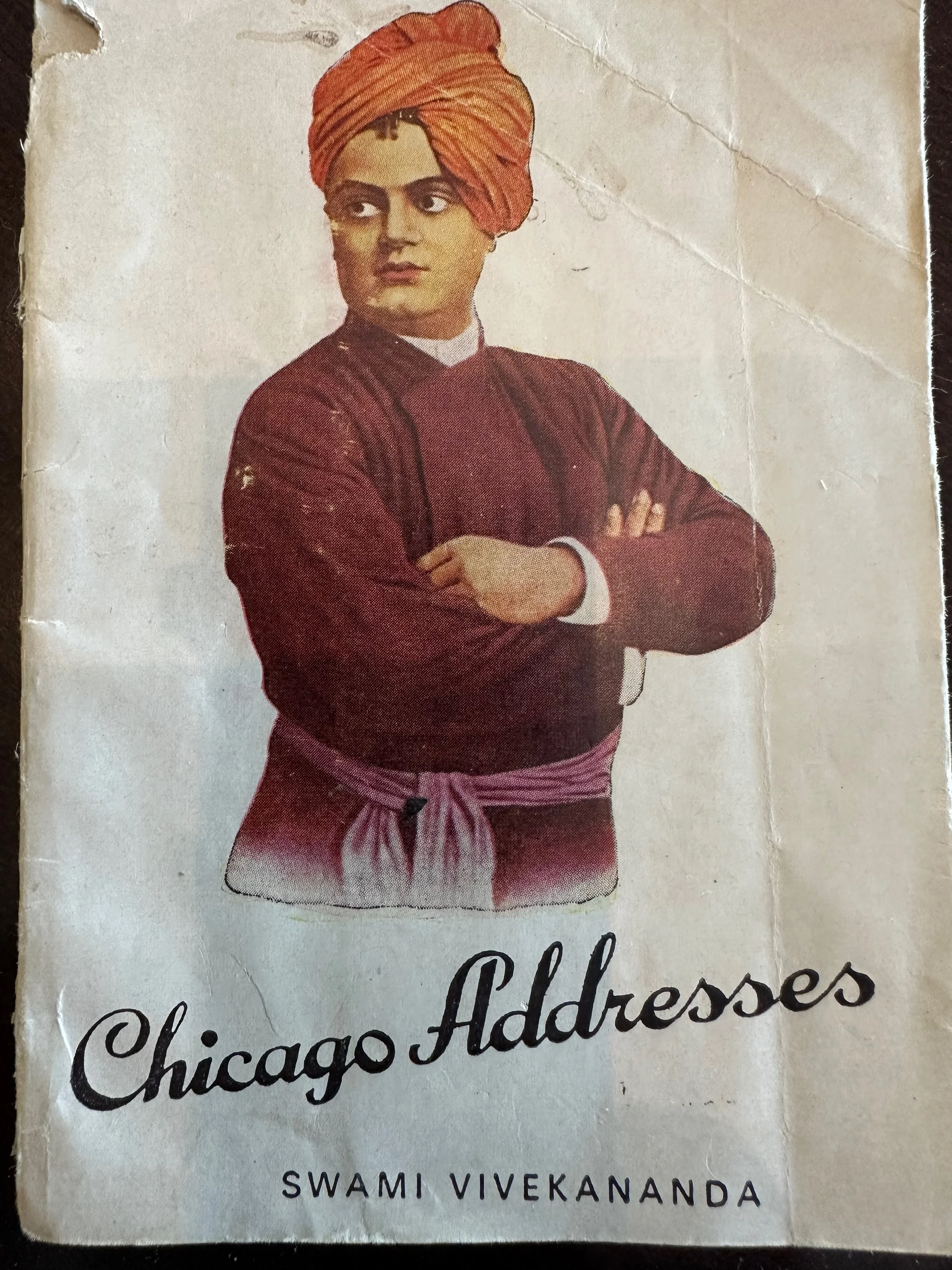 A vintage photo of a woman wearing a turban and traditional attire, with the words "Chico Addresses" and "Swami Vivekananda" written below.
