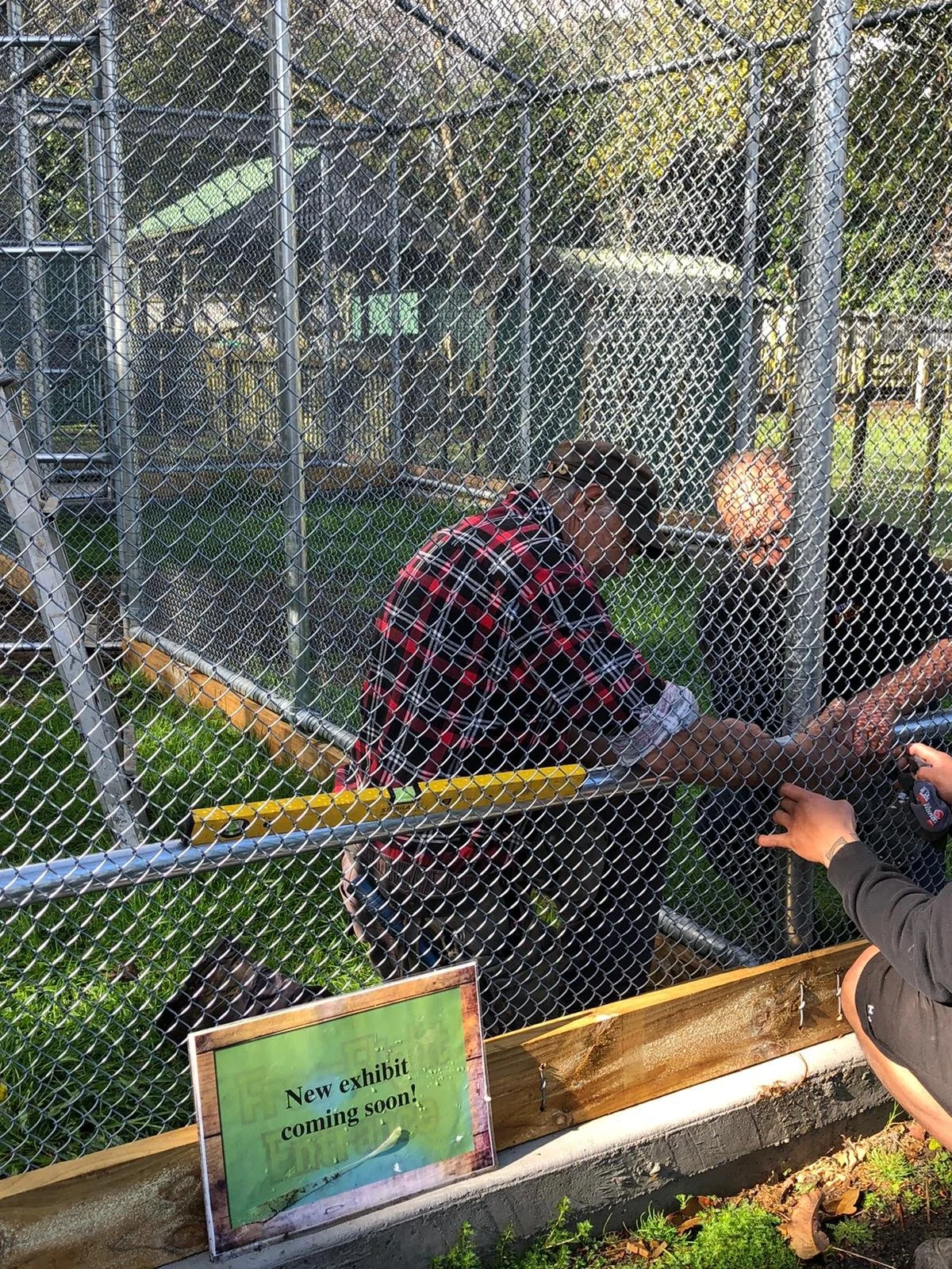 Two people working on a fence