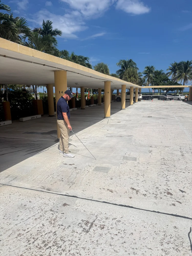 Colin McGrane performing a structural inspection at a concrete column and slab