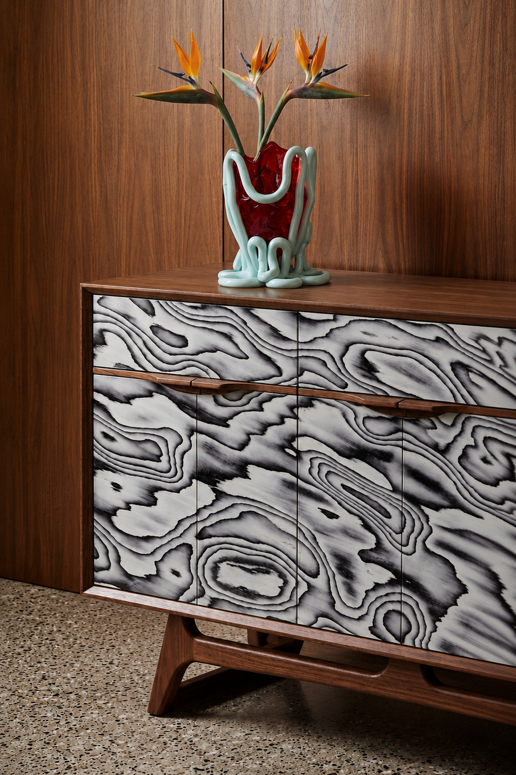 Custom walnut cabinet sideboard with statement mid century modern burl doors, styled with a sculptural vase by Design by Sop.