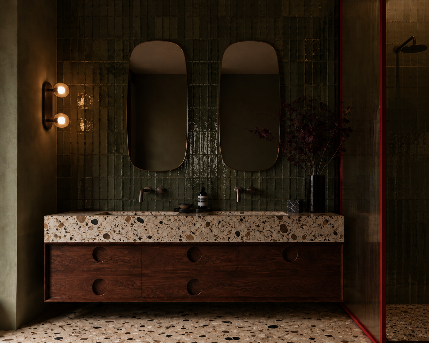 mid century modern fun Moody bathroom interior with custom timber vanity, terrazzo stone, green tiled walls and sculptural mirrors by Design by Sop.