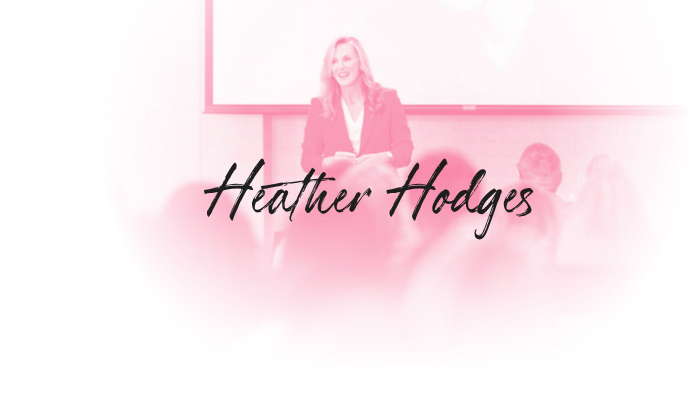 Heather Hodges speaking at a presentation with the name Heather Hodges displayed in front of her.