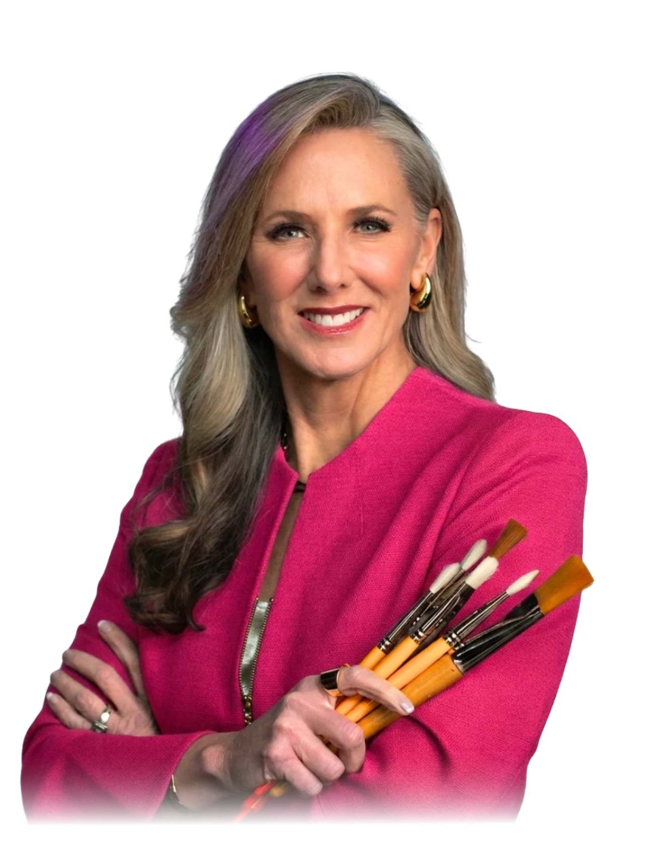Dr. Heather Hodges, healthcare keynote speaker and creativity researcher, holding paintbrushes in a pink blazer.