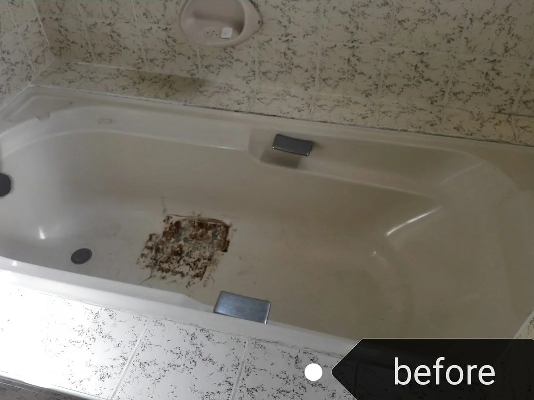 Old bathtub with rust and dirt in the bottom, surrounded by tiled walls and floor.