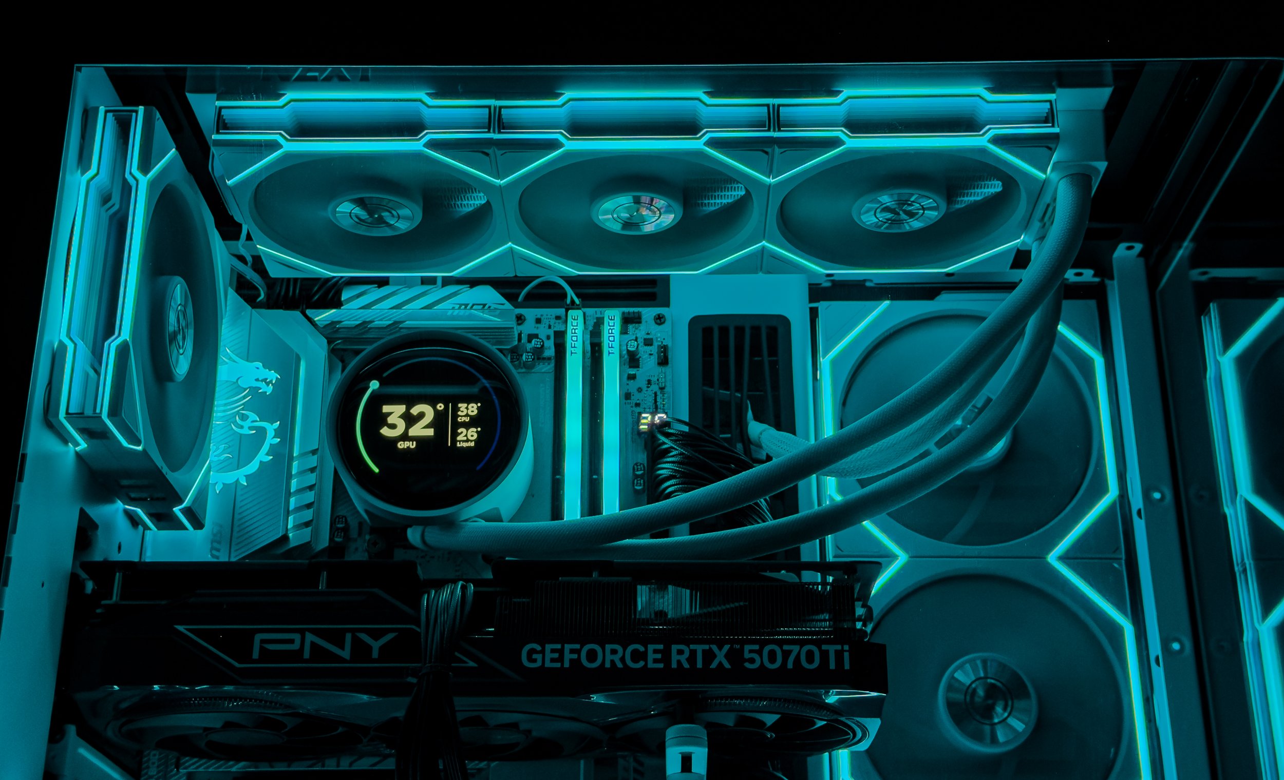 Close-up of a computer graphics card inside a custom-lit PC case with neon blue LED lights, showcasing cooling fans, power cables, and a liquid cooling system.