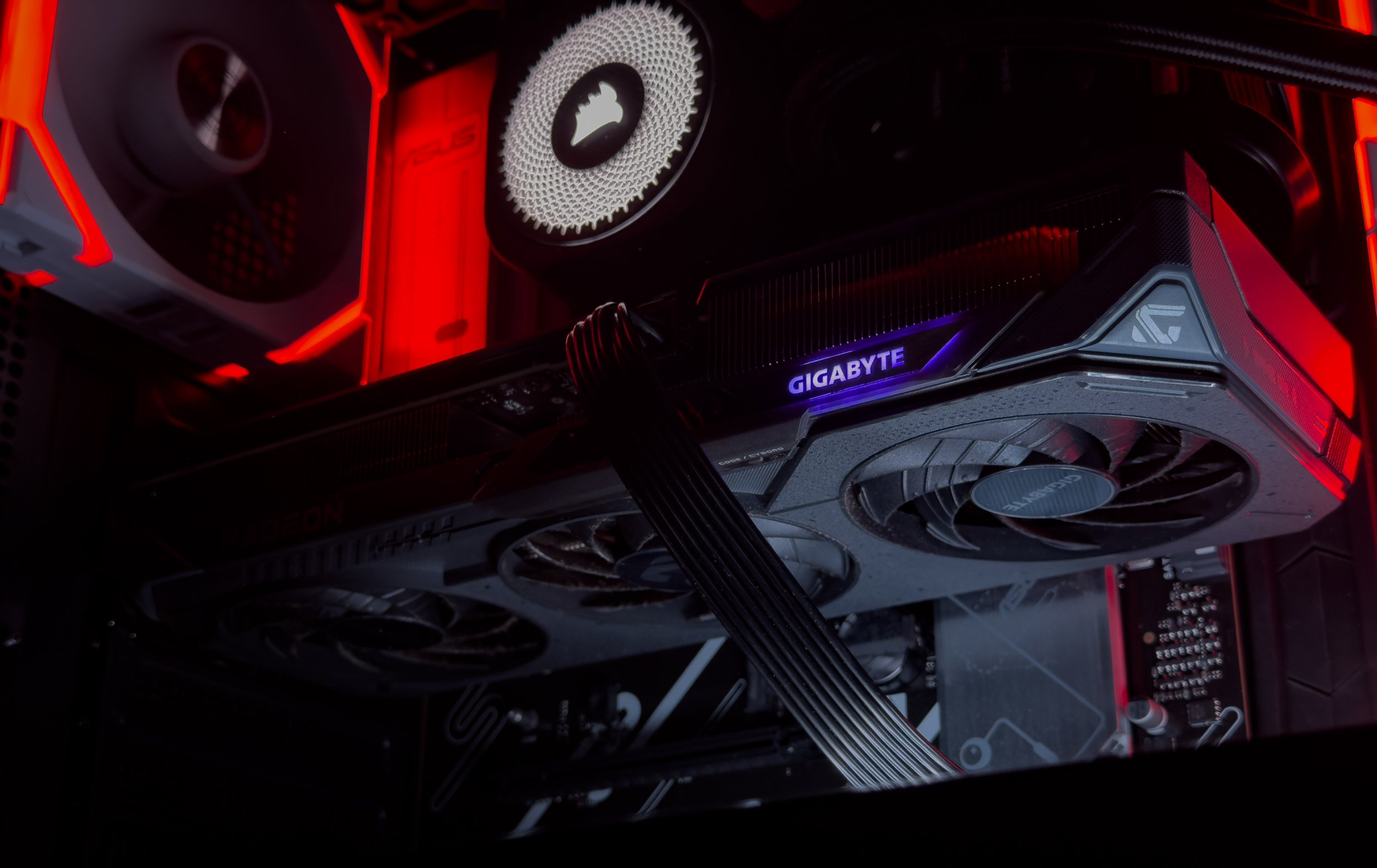Close-up of a computer graphics card inside a gaming PC with RGB lighting and the GIGABYTE logo visible.