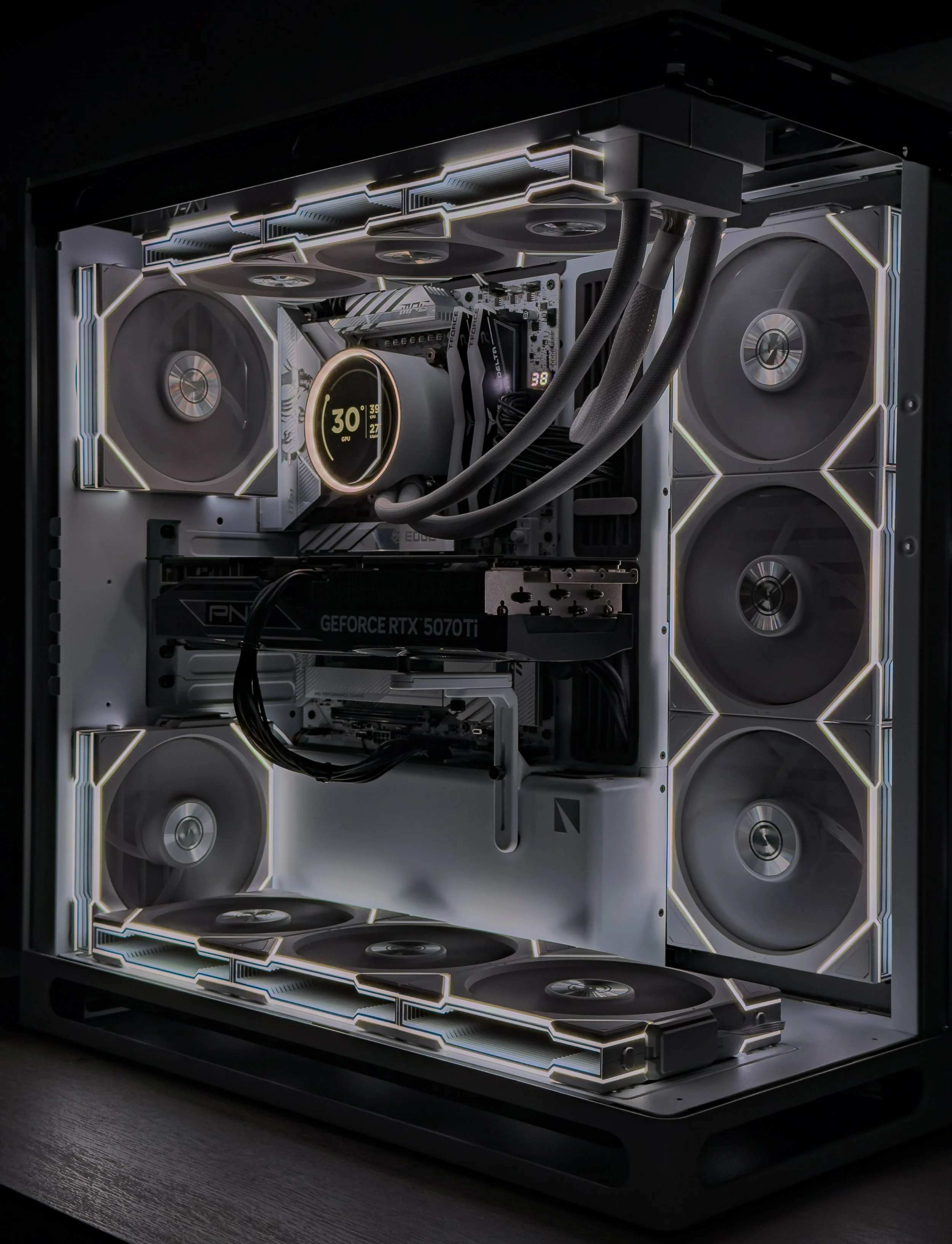 A custom-built gaming computer with an open case showcasing components, cooling systems, and LED lighting.