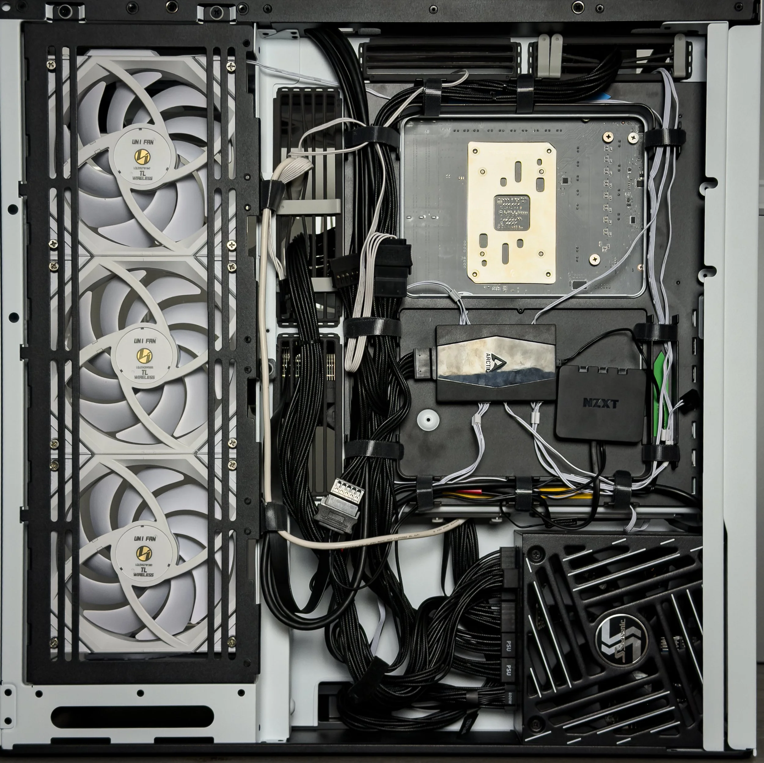 Inside a computer case with multiple cooling fans, cables, and hardware components visible.