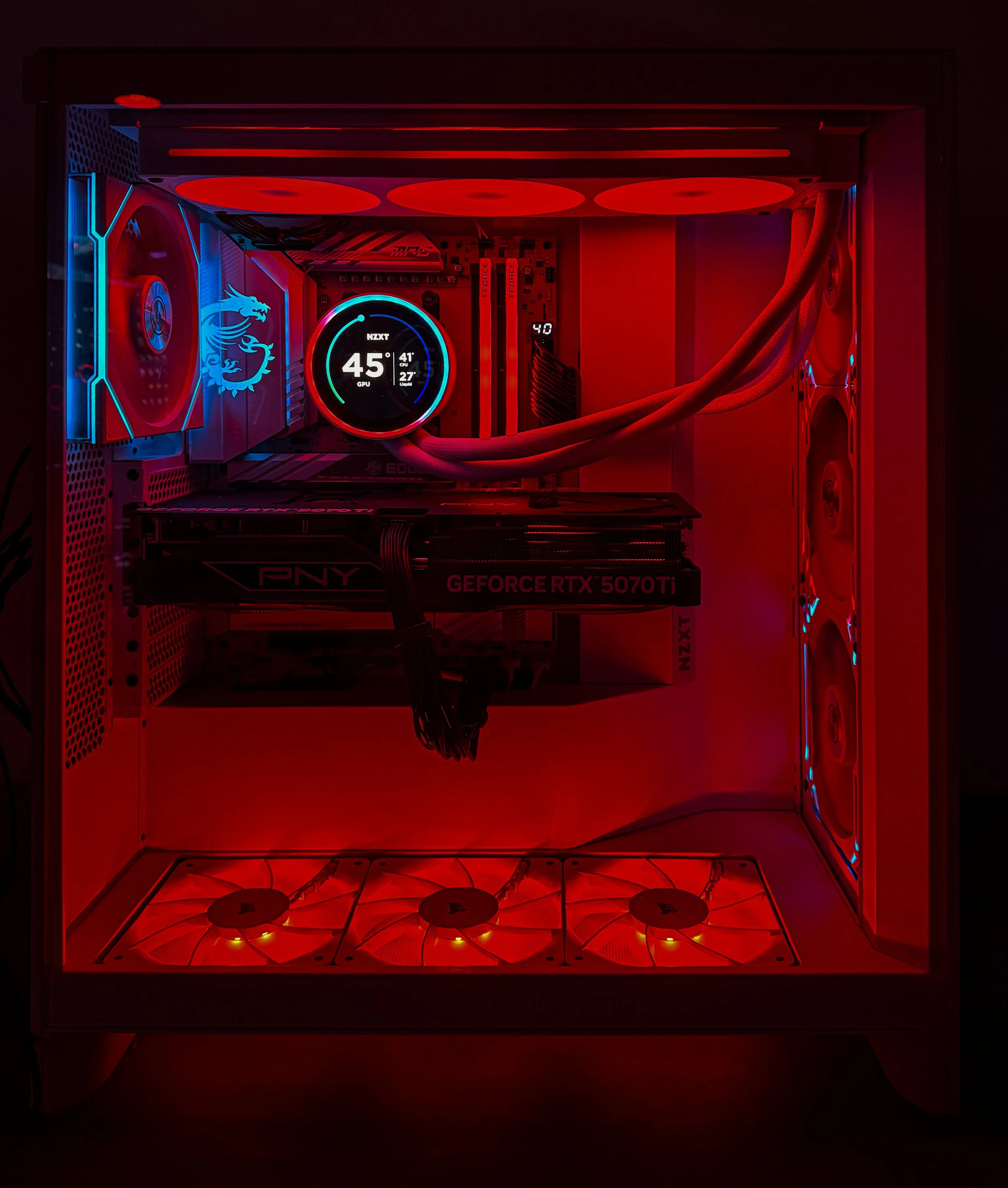 A gaming computer case with LED lighting, showing internal components like a CPU cooler, fans, RAM, and graphics card.