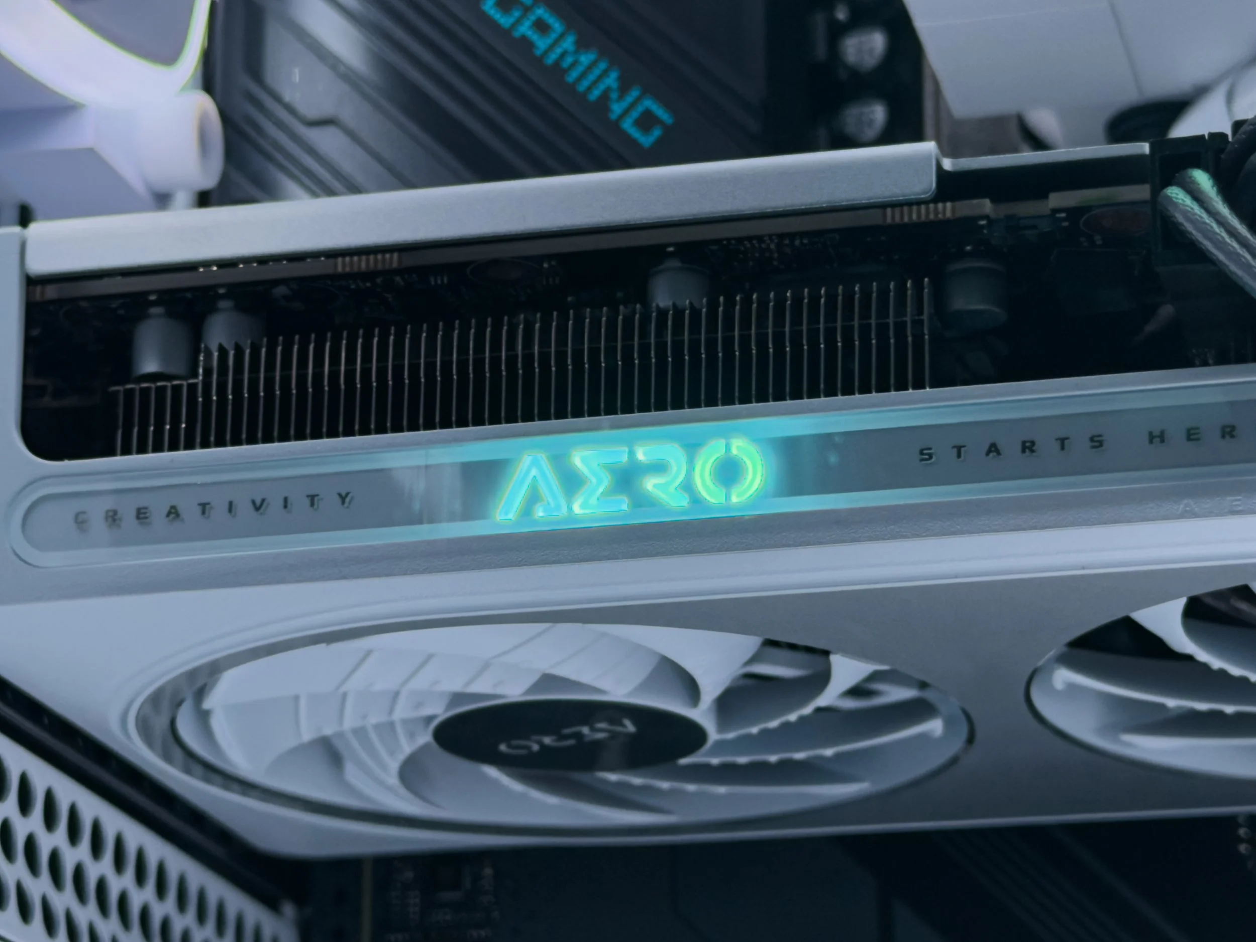 Close-up of a computer graphics card with a glowing display showing the text 'A520' and a cooling fan underneath.