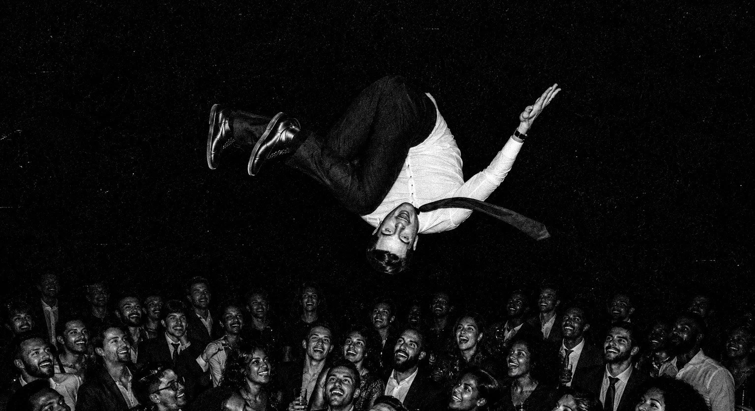 Man in suit falling backward over a crowd, stage diving, with text overlay "The decision matters. What happens next matters even more."