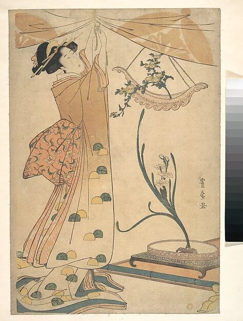 A woman beside a flower arrangement of chrysanthemums, by Utagawa Toyohiro, circa 1805