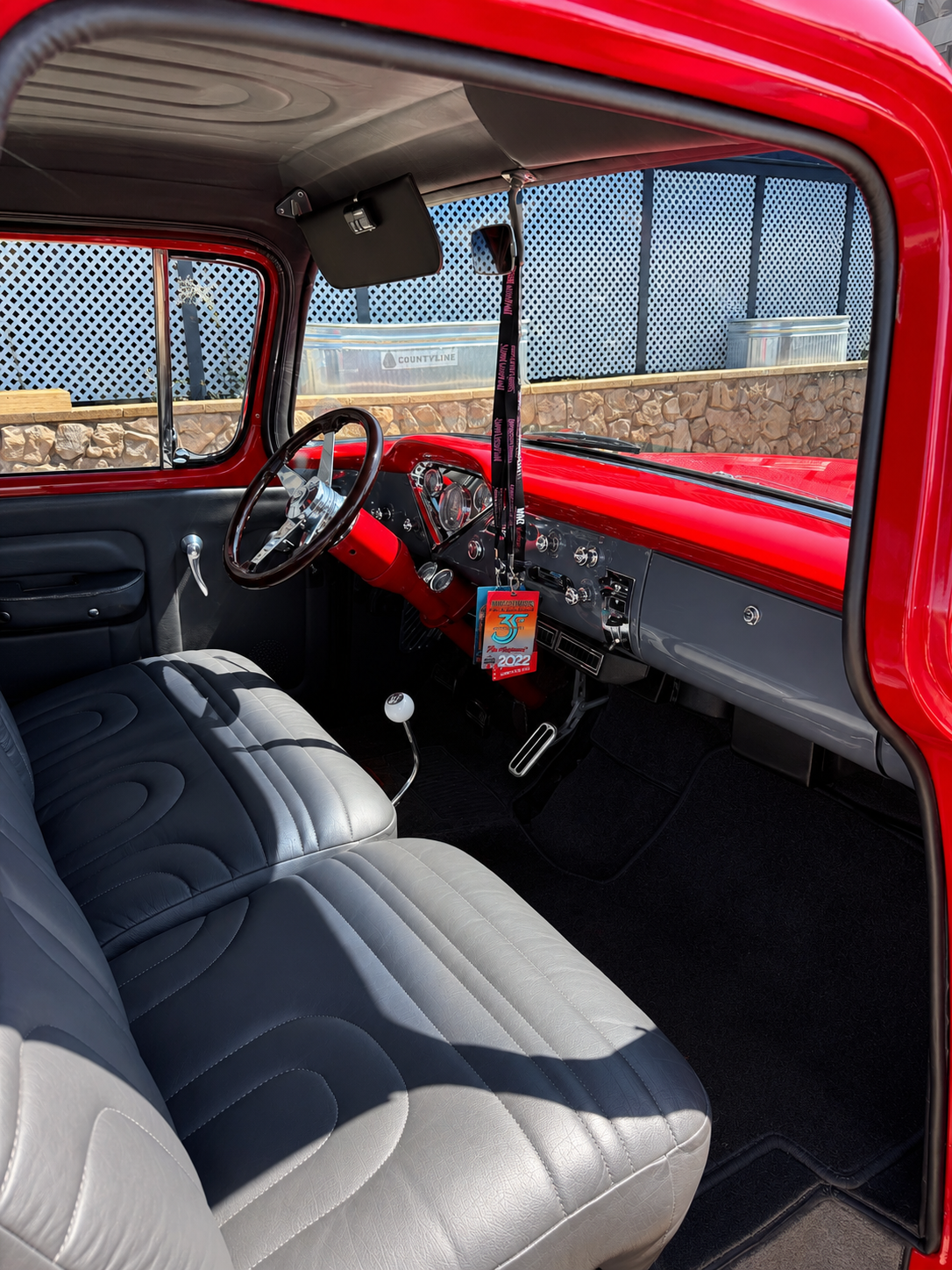 Vintage red truck interior with wooden steering wheel — vehicle detailed by J's Mobile Detailing, Roseville, CA.