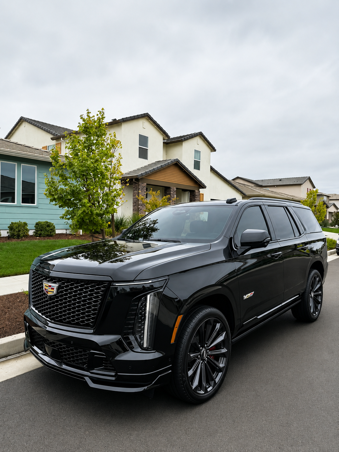 Detailed black Cadillac Escalade parked on a residential street in Roseville, CA.