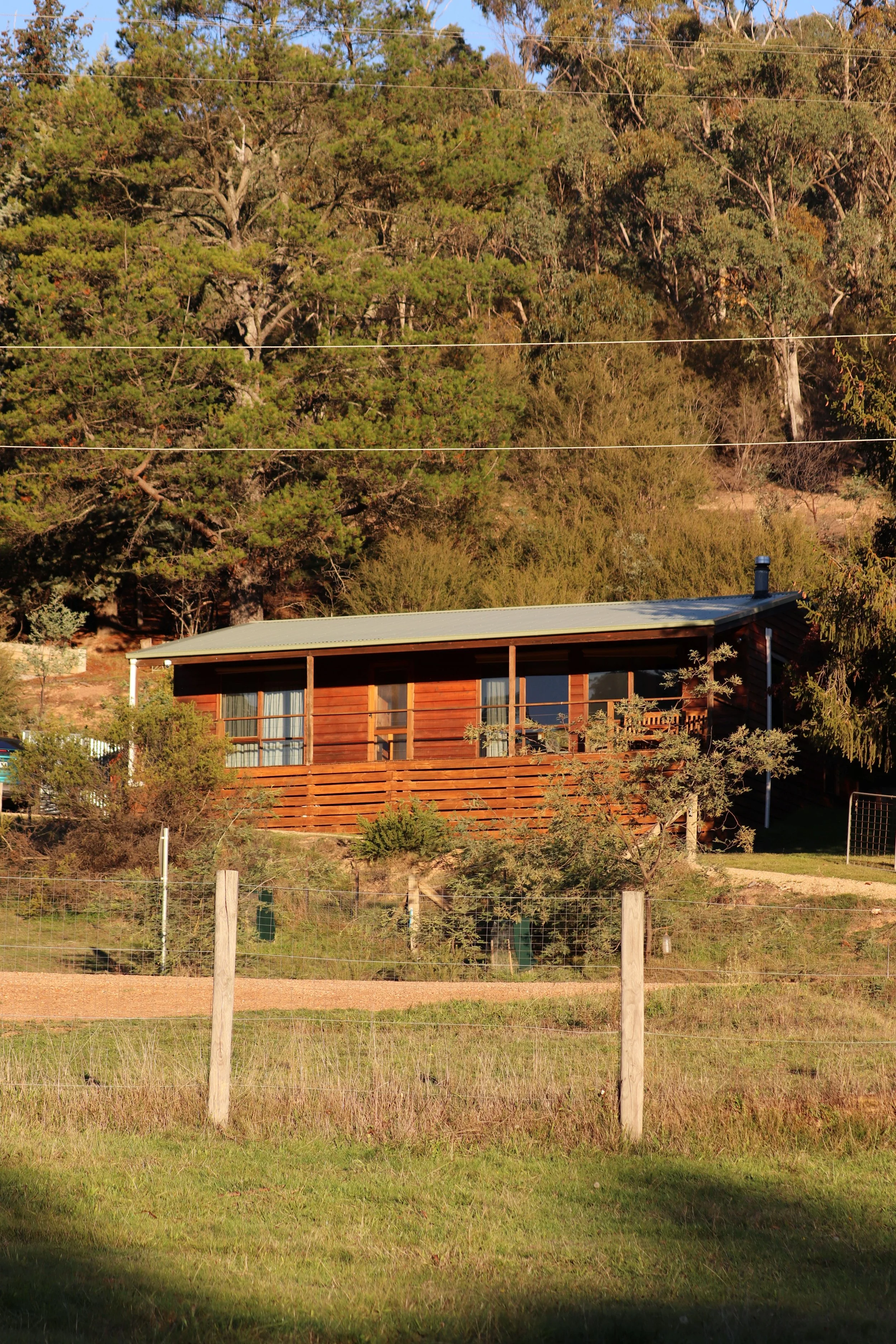 Howqua Hideaway is a 1970s cedarwood cabin with bush background in Howqua Valley, Victoria