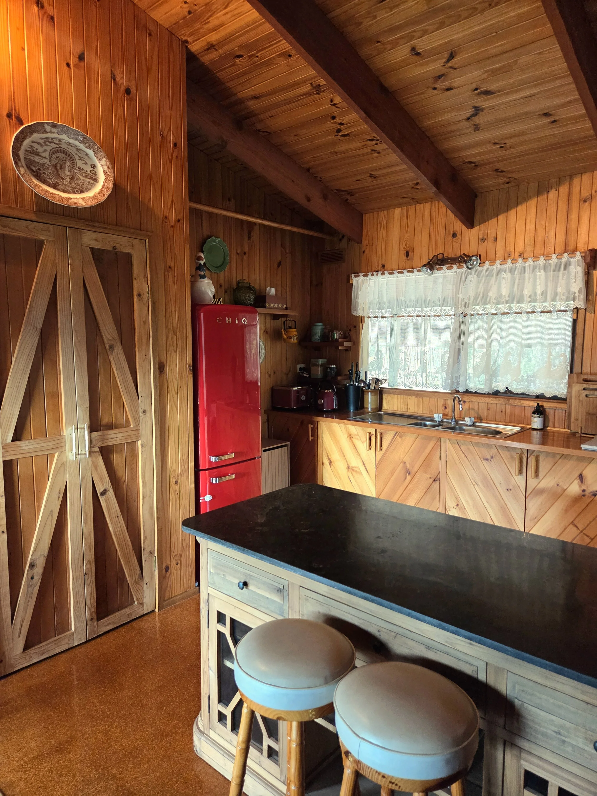 Howqua Hideaway cabin kitchen with retro red fridge, Howqua Valley, Victoria. Full kitchen