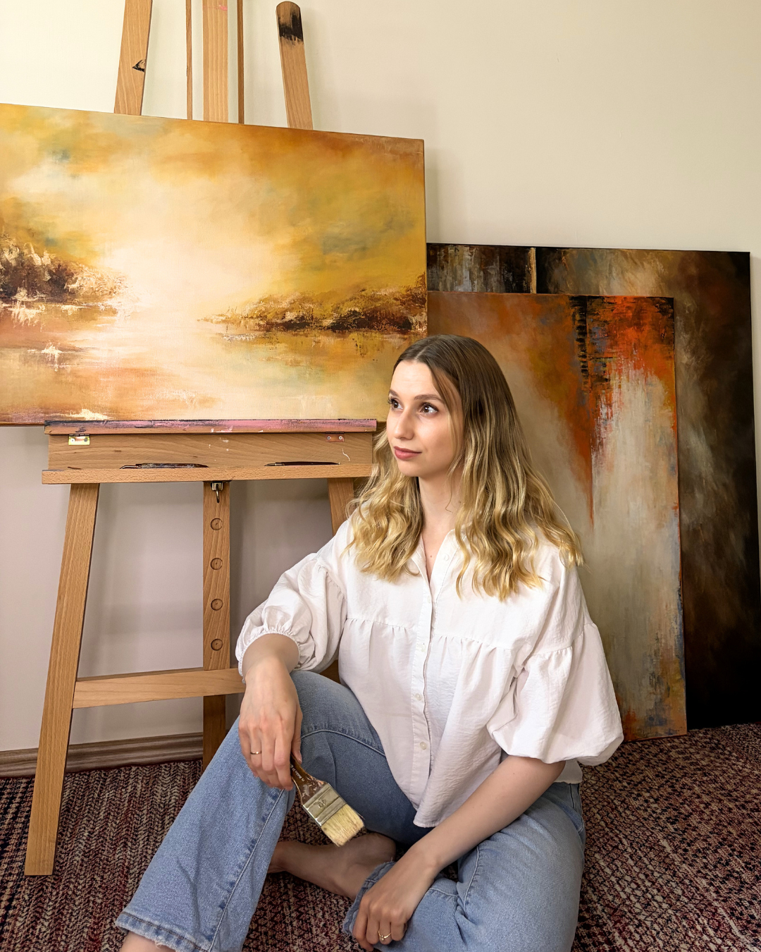 Lea Dékány in her Budapest studio with atmospheric acrylic paintings