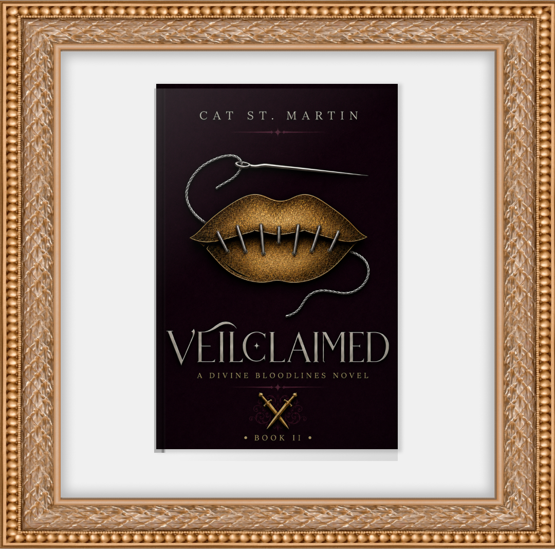 Book cover titled "Veilclaimed" by Cat St. Martin, labeled as Book II in the Divine Bloodlines series, featuring a gold lip-shaped brooch with pins and a needle, framed in an ornate gold frame.