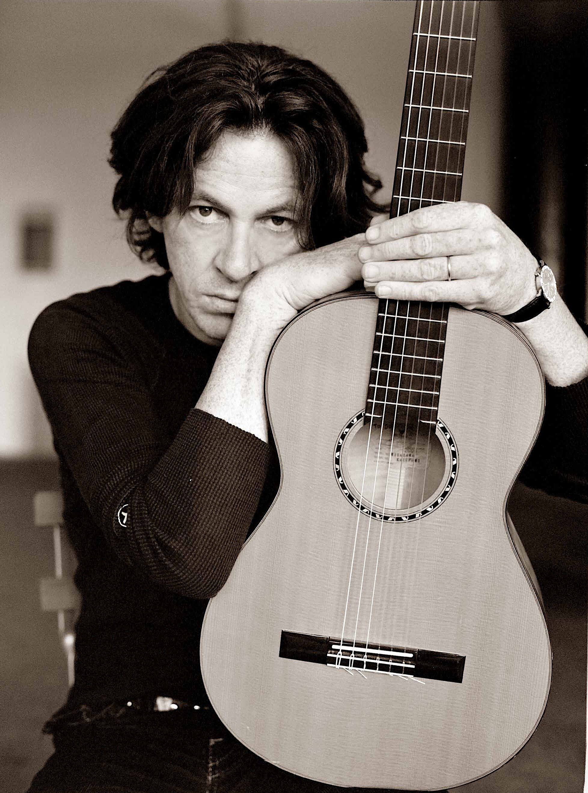 old picture of dominic miller with his CYTM k yairi guitar facing the camera