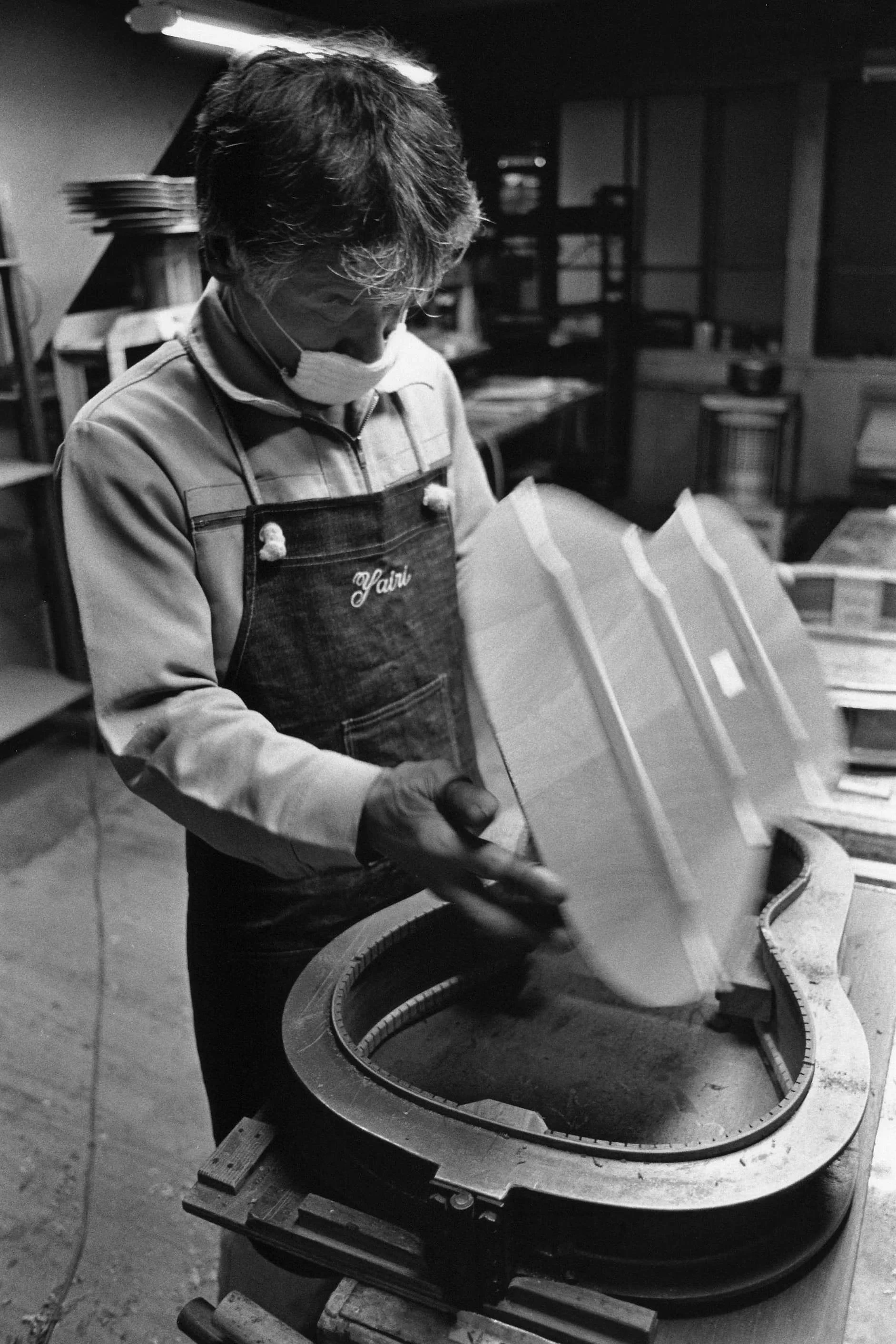 Un artisan Japonais travaille sur le dos d'une guitare dans les ateliers K Yairi