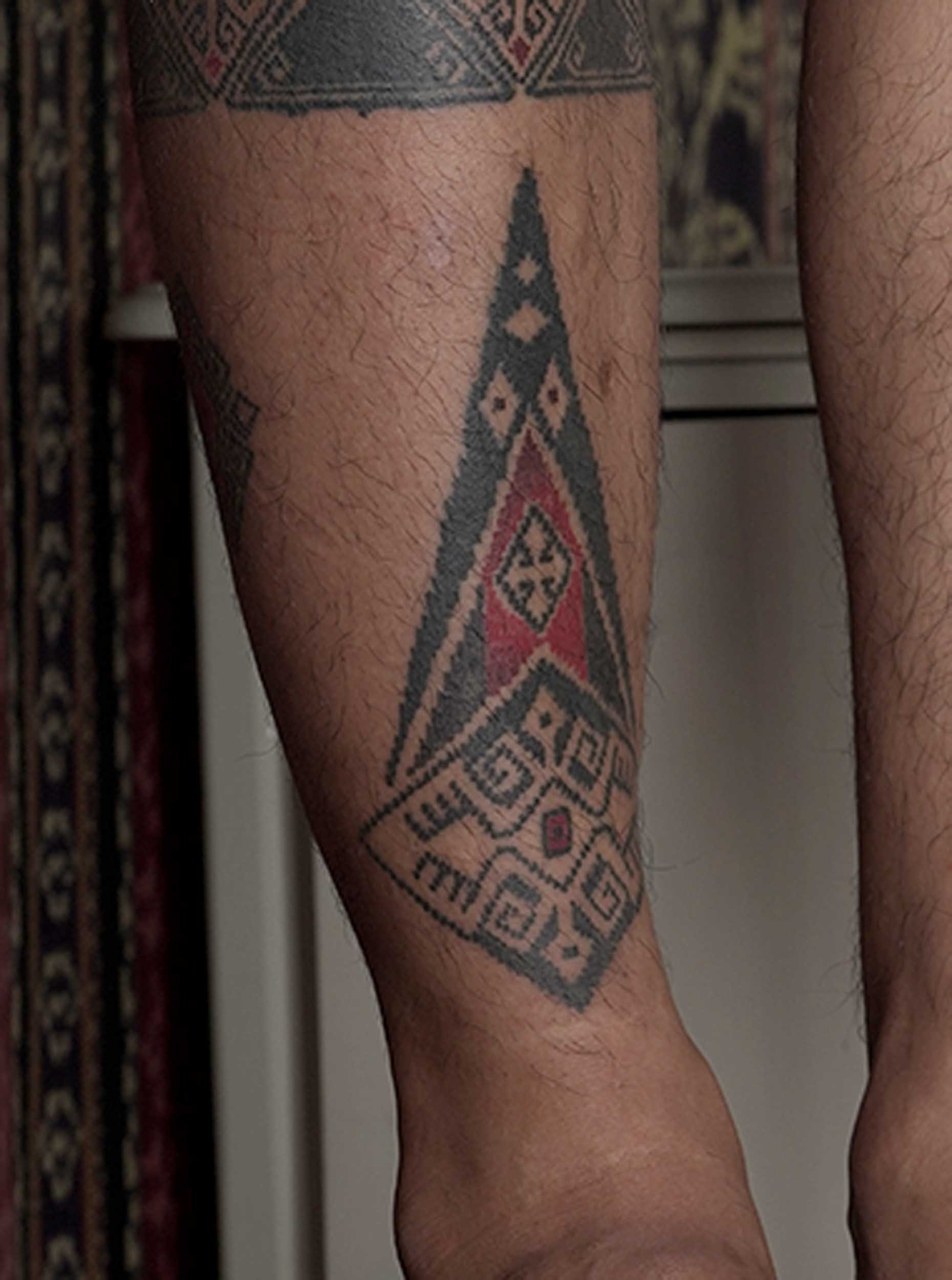 shin tattoo in ornamental style with tenun texture and pattern