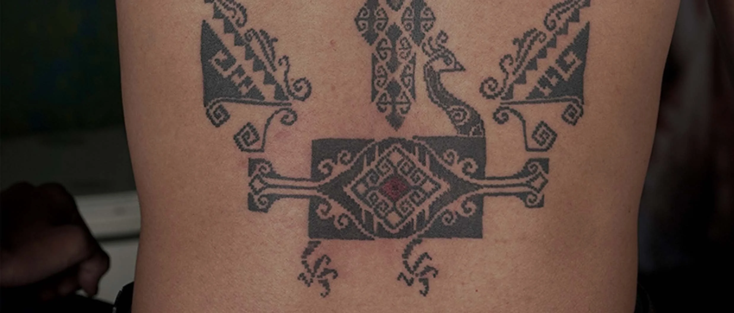 bold ornamental back tattoo in bali