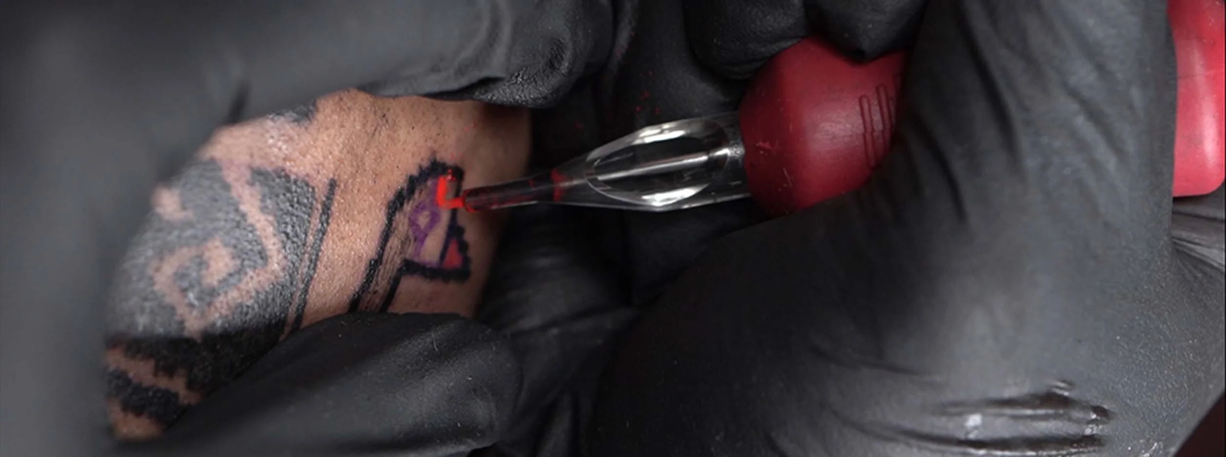 closed up of bali based tattoo artist doing his unique ornamental style with tenun texture
