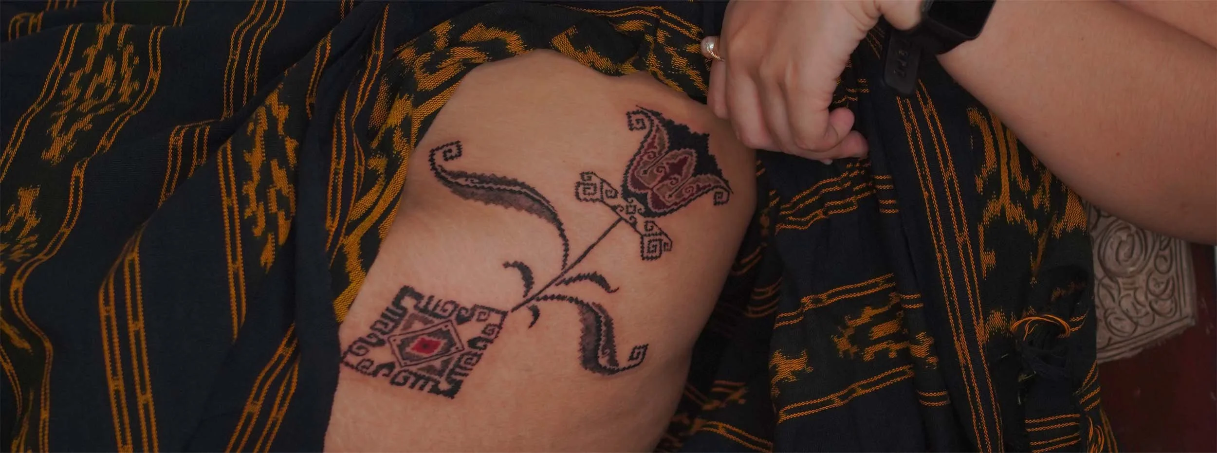 bold ornament thigh tattoo women in Bali IIndonesia