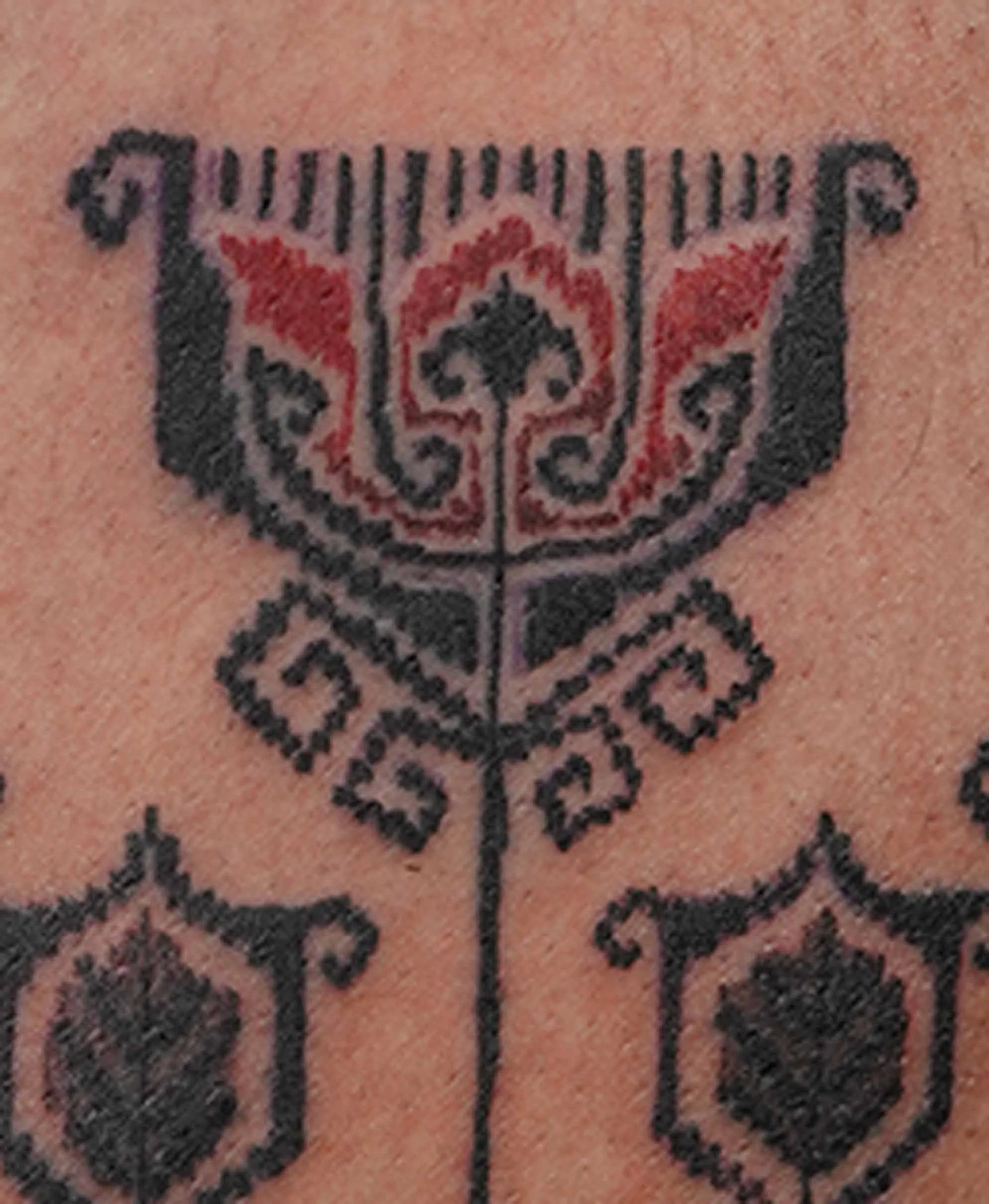 red tulip tattoo with tenun pattern