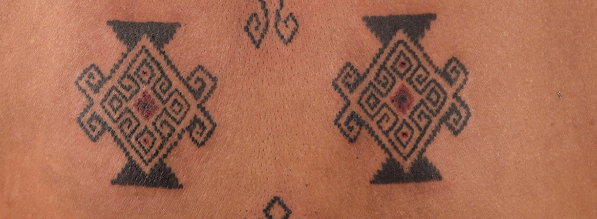 tenun tattoo on back placement