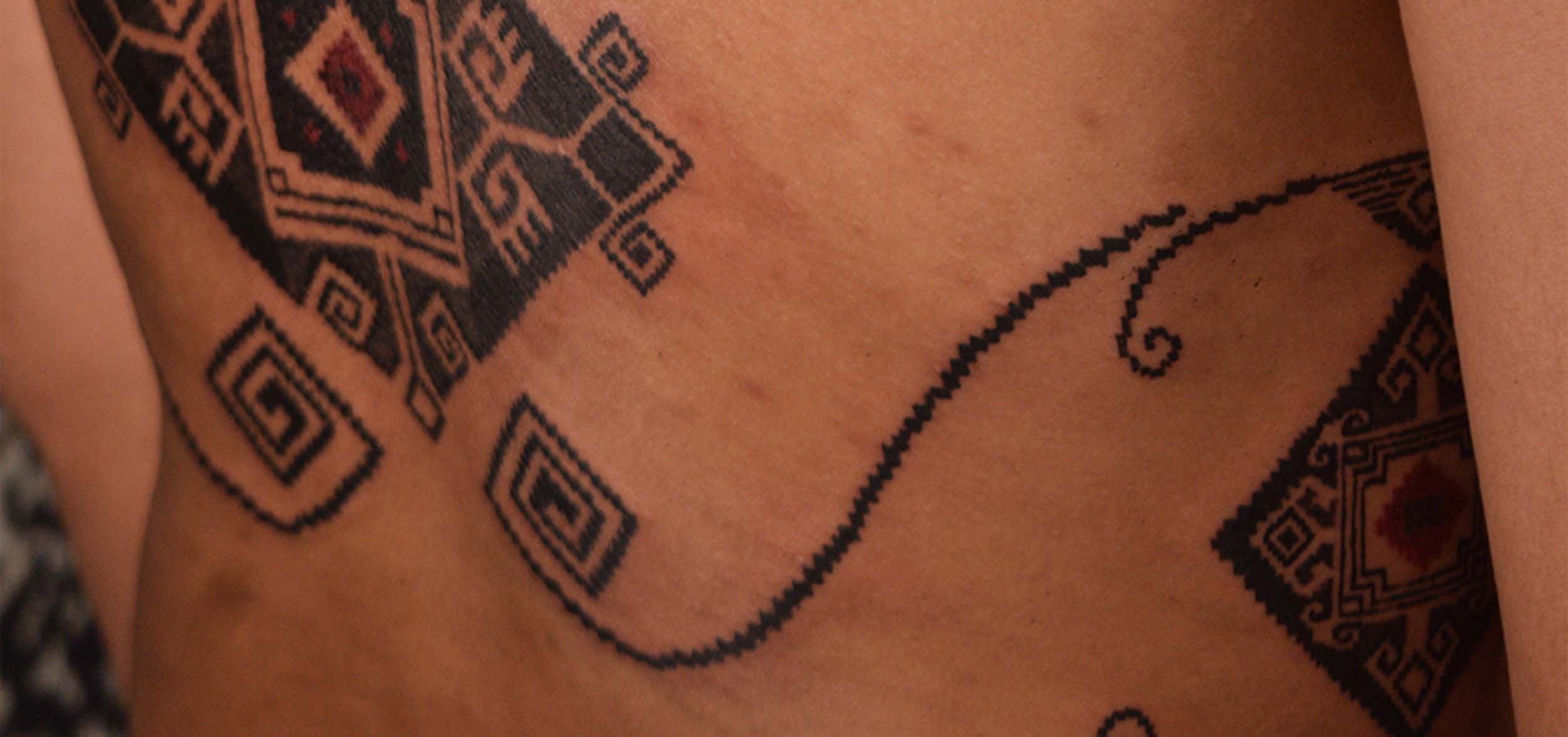 lower back and ribs tattoo in ornamental indonesia style