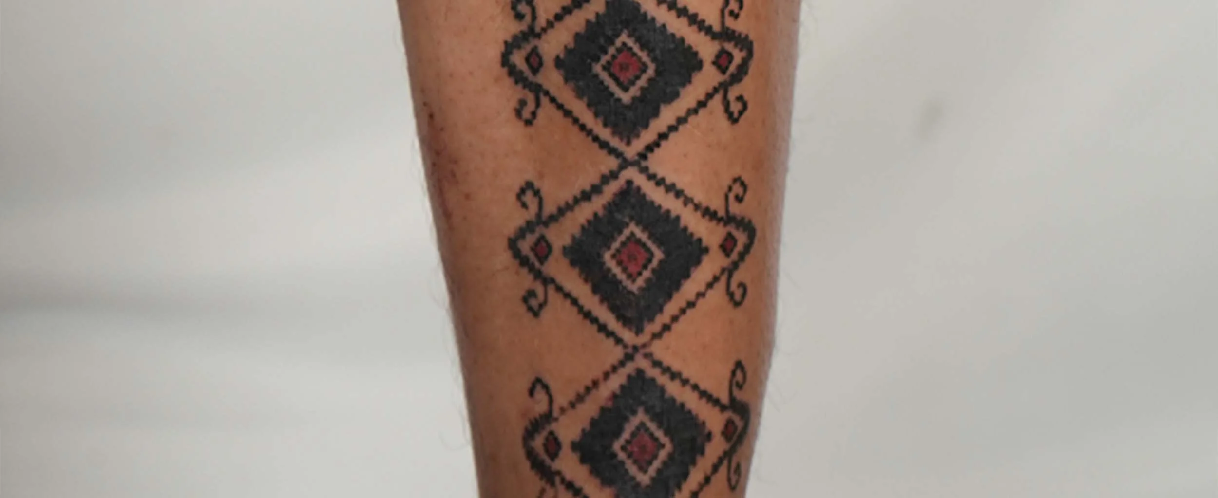 bold ornamental tattoo on man shin in canggu