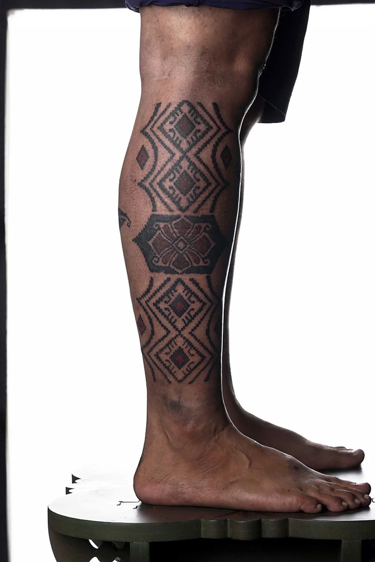ornamental leg tattoo with floral batik motif