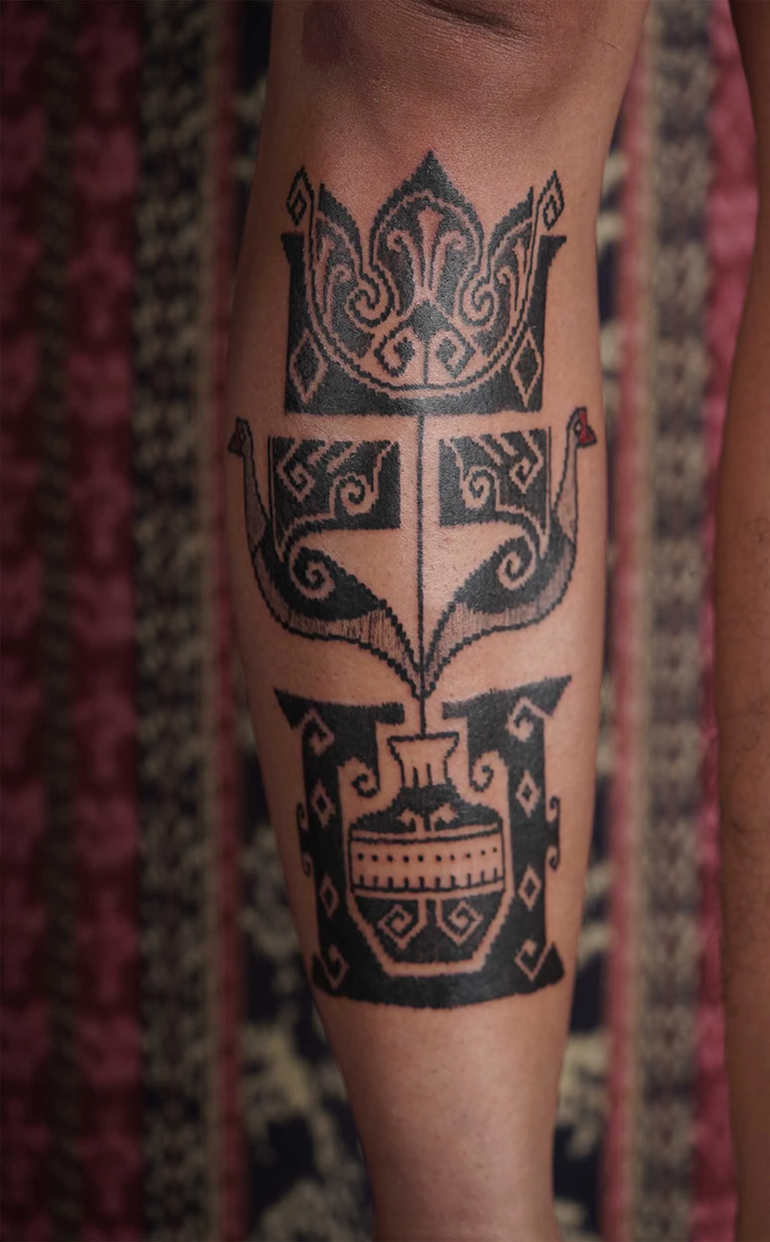 lower front leg flower tattoo in black work ornamental style