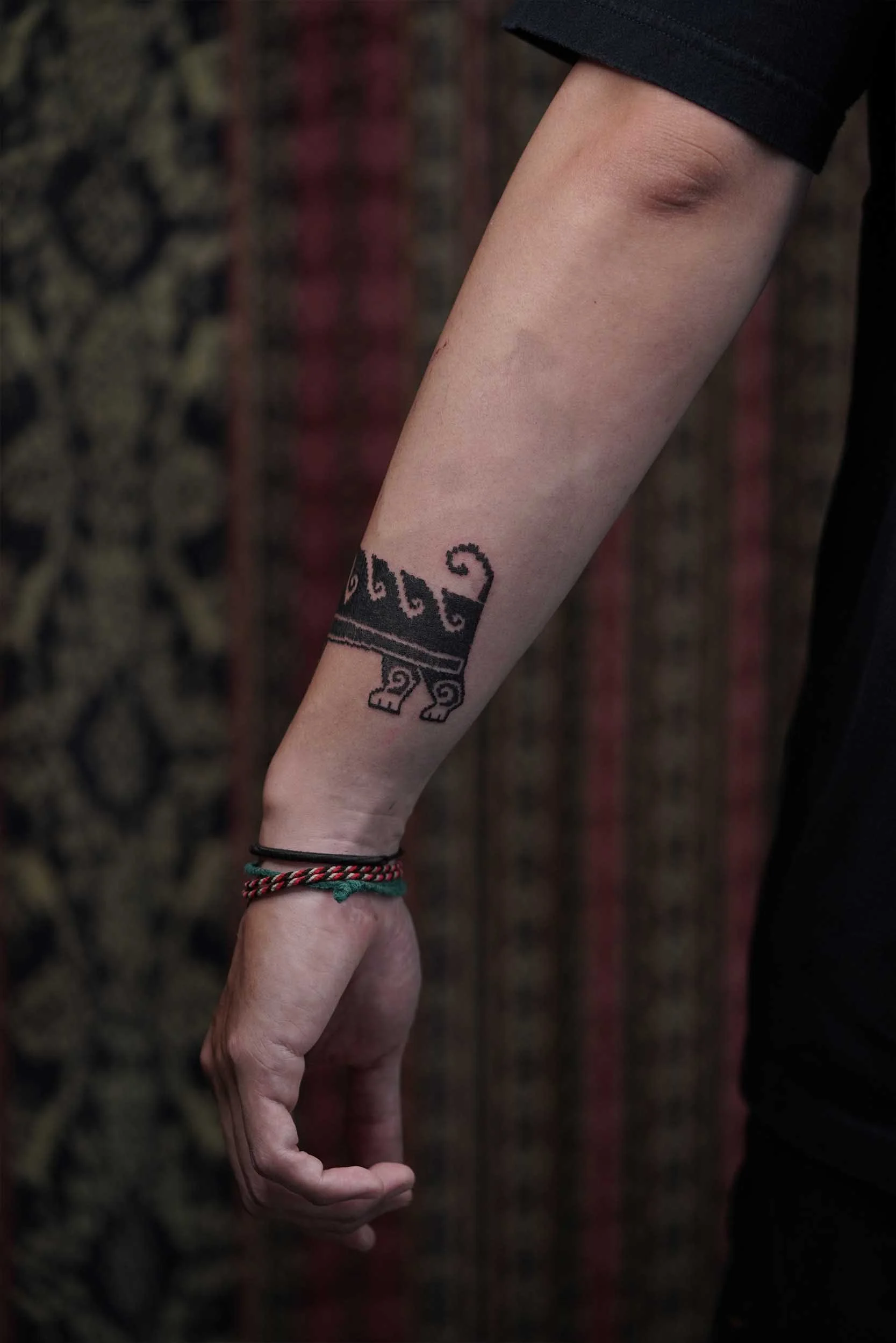 dog tattoo detail on its tail on the out side of arm