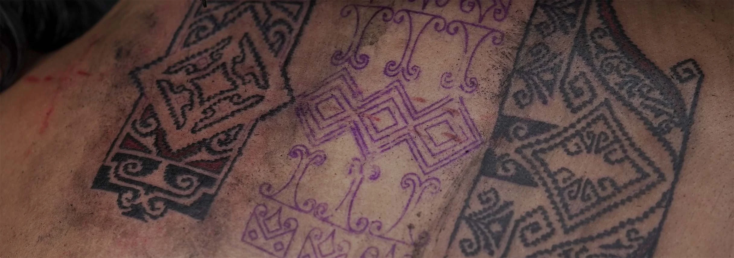 bali ornament tattoo on back placement with tenun motif
