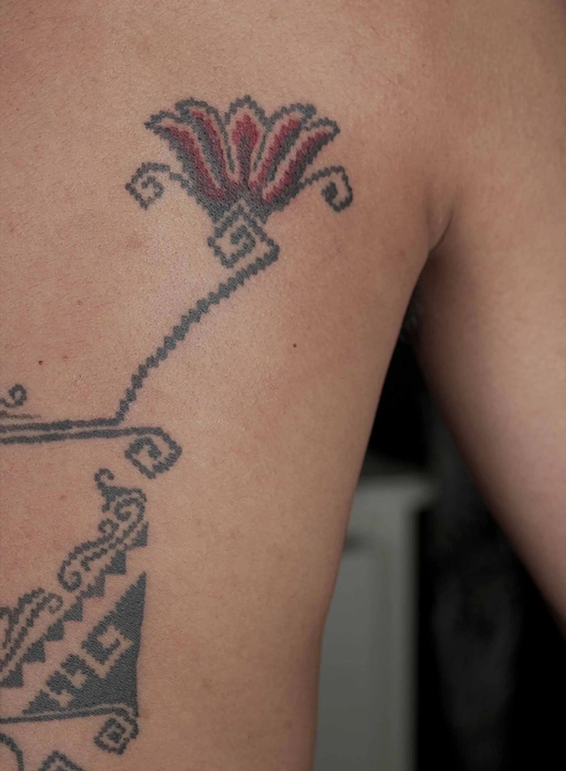ornamental flower tattoo on man back