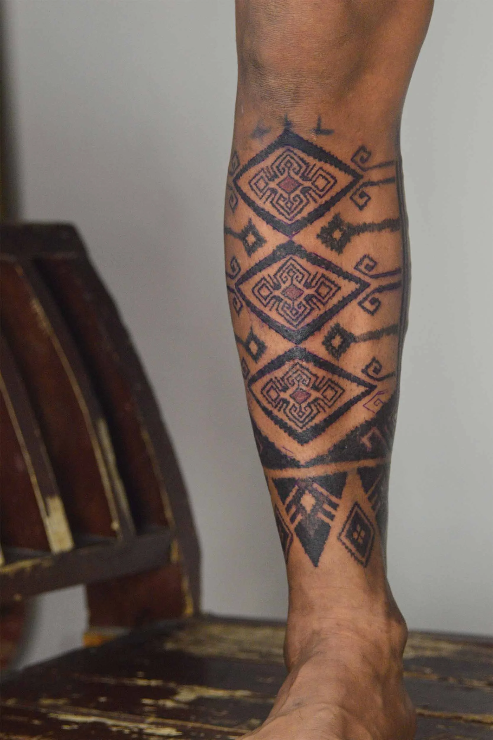ornamental style leg piece with repeating pattern on man shin