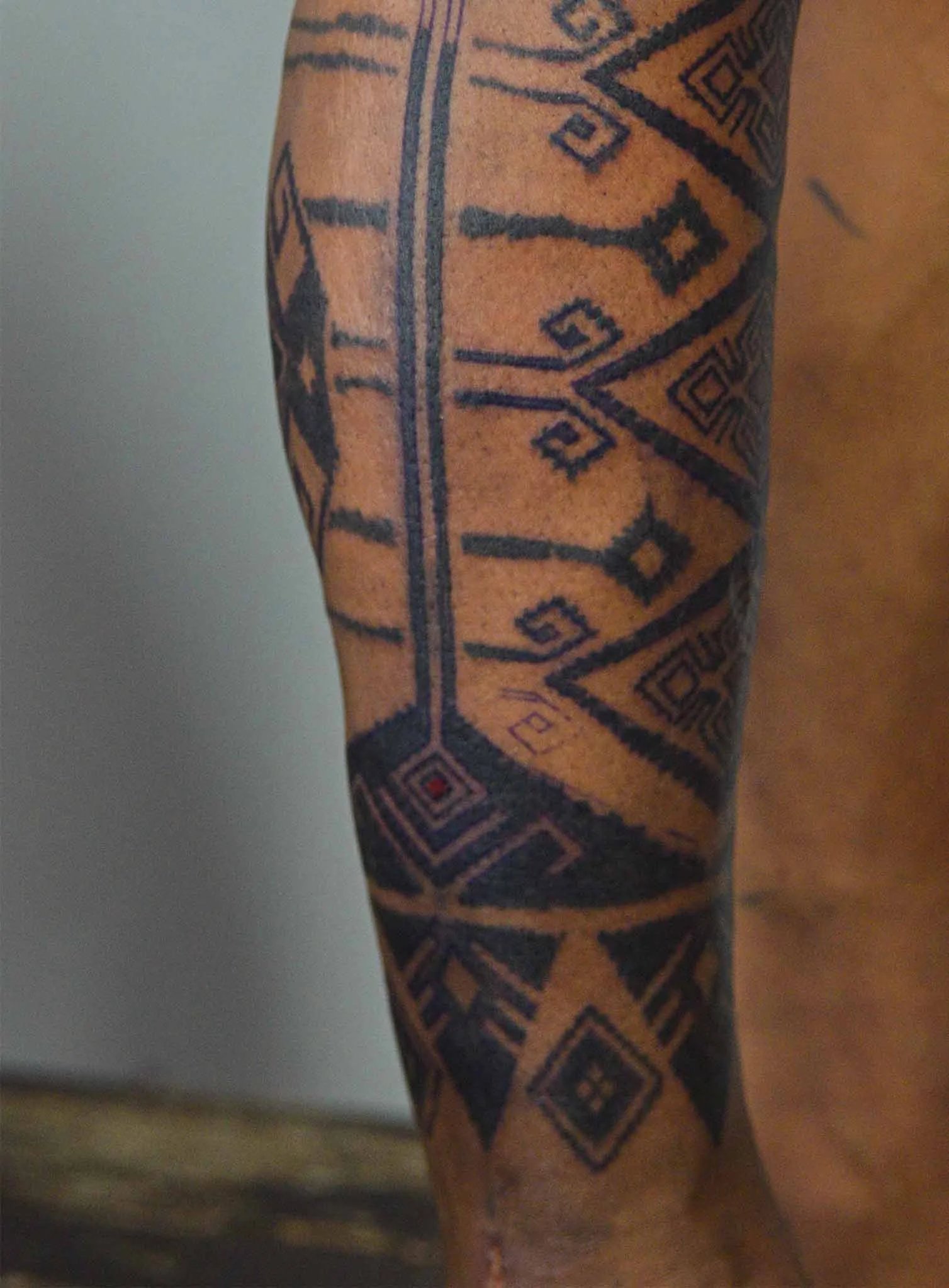 bold intricate ink on man shin by bali based tattoo artist in near kedungu tattoo studio