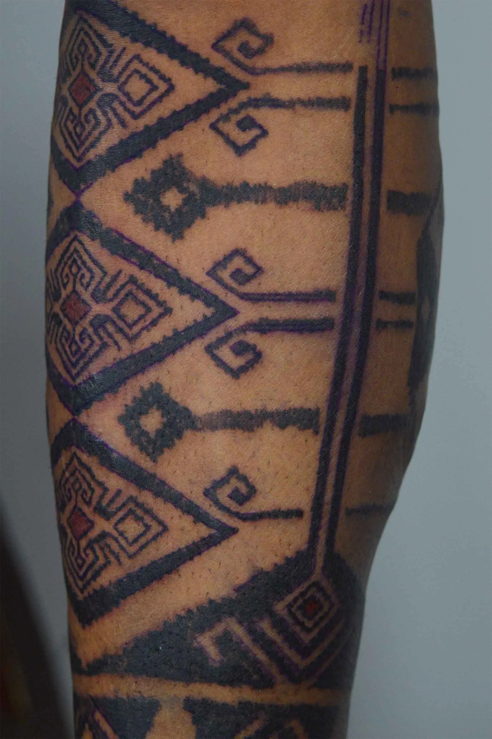 intricate ornament tattoo on mans lower leg by bali based tattoo artist