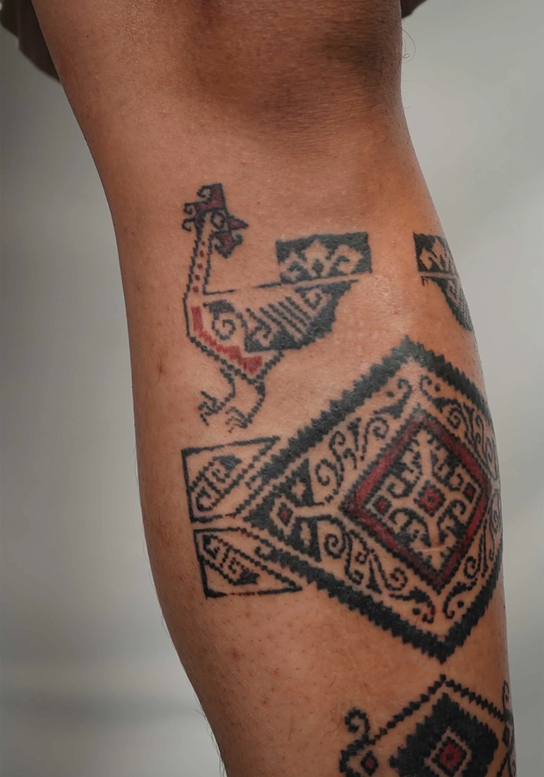 bali ornamental leg tattoo with unique concept by bali based tattoo artist